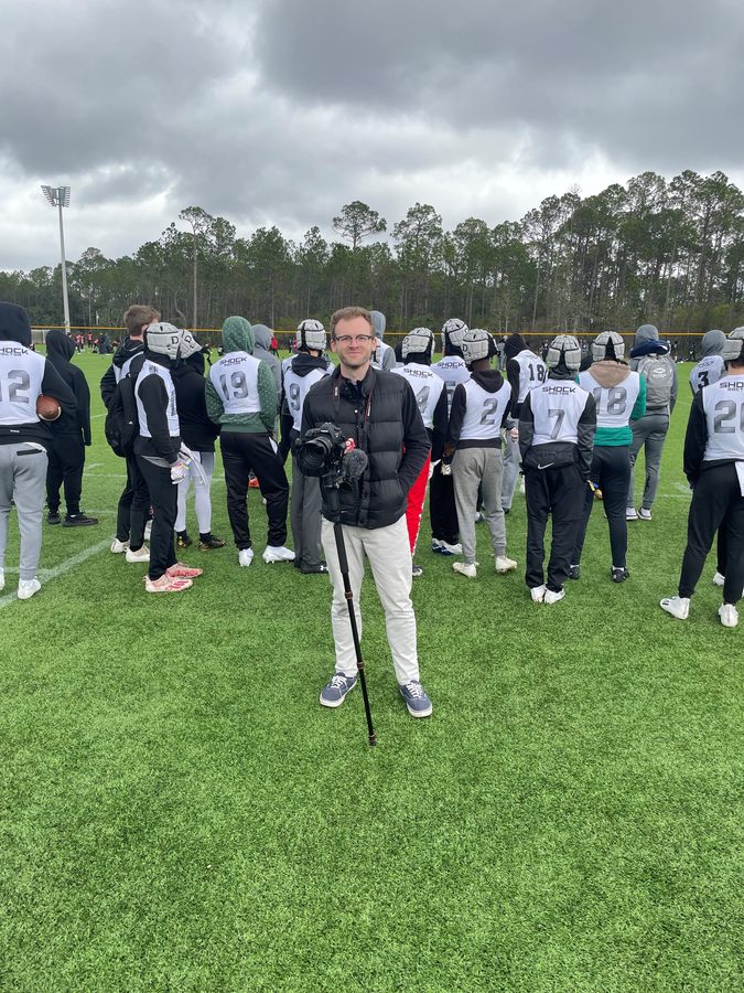 Eli shooting video at a sports team practice